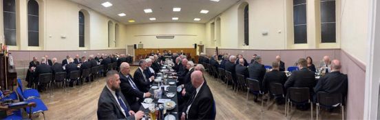Brethren sitting down for harmony after the installation